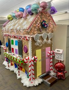 a gingerbread house decorated with candy canes and decorations