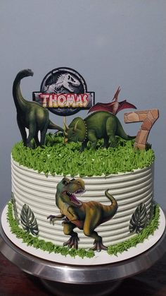 there is a cake with dinosaurs on it