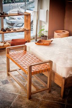 a wooden bench sitting in front of a bed