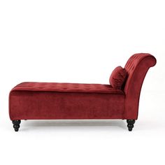 a red velvet chaise lounge with black legs