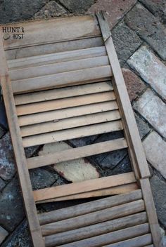 a wooden chair sitting on top of a brick floor