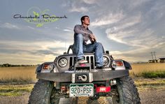 a man is sitting on top of a four - wheeler in the middle of nowhere