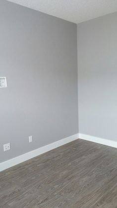 empty room with hard wood flooring and white paint on the walls in an apartment