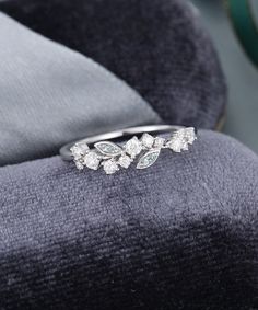 a diamond ring sitting on top of a velvet cushion