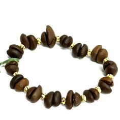 a bracelet made out of coffee beans and gold beads