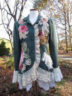 a green jacket with white lace and flowers on it