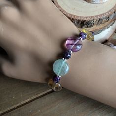 Stone bracelet purple fire agate bracelet gemstone fluorite bracelet handmade circle bracelet boho stone lilac unique bracelet for women This beauty has 12mm multi color purple fluorite stones, 6mm purple fire agate, faceted, silver plated findings and lobster claw closure. Unique jewelry for women. Length: 8 inches Who doesn't love a beautiful bracelet. I search the world over for some of the best stones and beads and also create my own so you can jazz up that most forgotten wrist. Treat yourse Handmade Adjustable Fluorite Bracelets, Purple Bohemian Round Bracelet, Bohemian Purple Round Crystal Bracelet, Fluorite Bracelet, Fluorite Stone, Purple Fire, Purple Fluorite, Circle Bracelet, Summer Bracelets