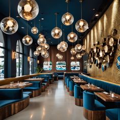 the interior of a restaurant with blue booths and round lights hanging from the ceiling above