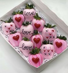 a box filled with lots of pink chocolate covered strawberries