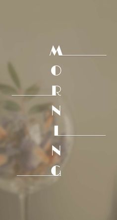 the word morning is written on top of a glass vase