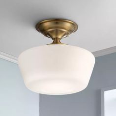 a light fixture in a room with blue walls