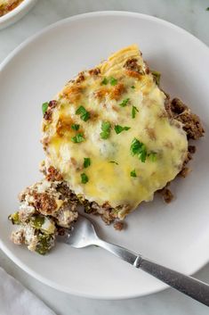 a close up of a plate of food with broccoli and cheese on it