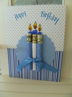 a birthday card with two candles on top of each other and the words happy birthday written in blue