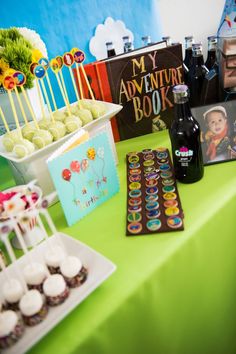 a table topped with lots of cupcakes and desserts on top of it