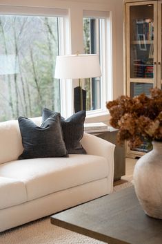 a living room filled with furniture and a large window