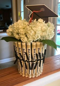 a vase filled with white flowers on top of a wooden table