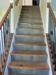 a set of stairs leading up to a second floor with metal railings and wood handrails