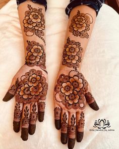 two hands with henna designs on them