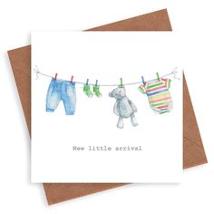 a card with clothes hanging on a line and a teddy bear next to it that says, new little arrival