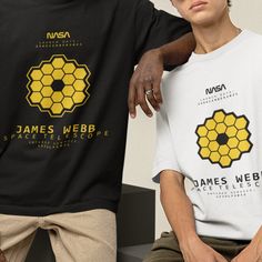 two men sitting next to each other wearing t - shirts with the same design on them