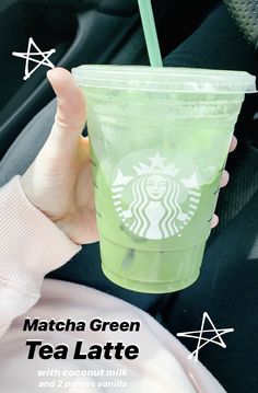 a person holding up a green starbucks cup with straw in it's hand and the words matcha green tea latte written below