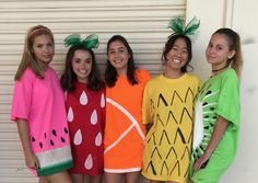 four girls in fruit costumes posing for the camera