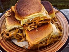 two pulled pork sandwiches stacked on top of each other