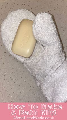 a pair of white bath mitts sitting on top of a counter next to a bar of soap