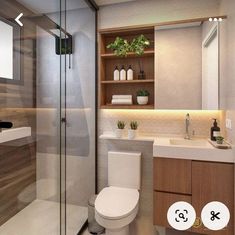 a bathroom with a toilet, sink, and shower stall in the middle of it