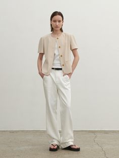 Casual and minimal jacket that has stretchy and lightweight texture. Featuring the basic rounded neckline, welt pockets, and the wood buttons detail. The oblique seam lines at front and back creates slim silhouette. Style with t-shirts and denim jeans to complete the daily looks. - Rounded neckline and half-sleeved design- Oblique seam lines at front and back- Welt pockets at front- Four-button closure at front- Loose silhouette and standard length Tailored Beige Tops For Work, Spring Crew Neck Workwear Outerwear, Spring Crew Neck Outerwear For Work, Casual Tailored Single Breasted Top, Casual Tailored Single-breasted Top, Casual Single-breasted Tailored Top, Casual Short Sleeve Blazer With Button Closure, Wood Buttons, Rounded Neckline