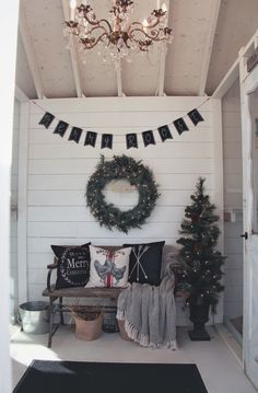 a room decorated for christmas with wreaths and decorations