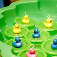 several rubber ducks are sitting in a green tray