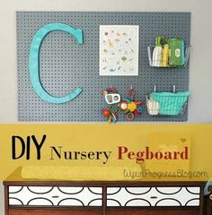 there is a sign that says diy nursery pegboard on the wall above it