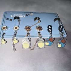 there are many key chains attached to the tray on the table, including one with an earring