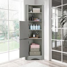 an open gray cabinet in the corner of a room