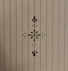 a cross painted on the side of a door with pins and lines around it,