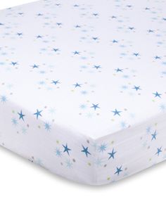 an image of a baby crib sheet with blue and white stars on the top