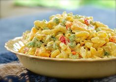 a bowl filled with macaroni salad on top of a table