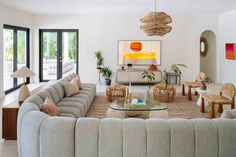 a living room filled with furniture and lots of windows