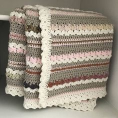 a crocheted sweater hanging on a clothes rack