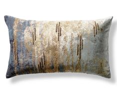 a decorative pillow with gold and silver designs