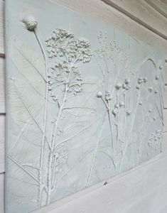 a close up of a flower on a wall