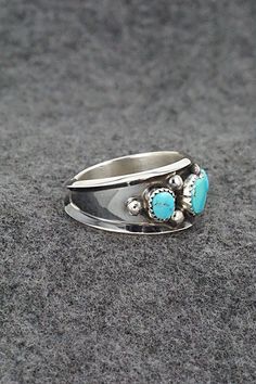 This turquoise and sterling silver ring was made by Navajo silversmith Paul Largo. The inside is stamped sterling.Size: 10Length: 1/2"Free shipping on all orders! We ship with USPS and always include tracking. All orders ship within a day of payment.Returns are accepted up to 30 days after you receive your order. Just send us a message. Our shop offers cash back or store credit. The item must be returned in new condition. Sterling Silver Turquoise Ring With Concho, Sterling Silver Turquoise Rings With Concho Detail, Southwestern Turquoise Ring In Sterling Silver, Southwestern Sterling Silver Turquoise Ring For Anniversary, Sterling Silver Turquoise Concho Ring, Untreated Turquoise Ring In Sterling Silver For Anniversary, Untreated Turquoise Sterling Silver Ring For Anniversary, Silver Turquoise Concho Ring In Sterling Silver, Southwestern Sterling Silver Rings For Anniversary