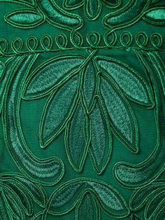 an image of green fabric with leaves on it