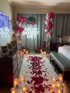 a wedding aisle with rose petals on the floor and candles in front of it that read, all you need is merry me