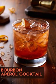 bourbon aperoli cocktail in a glass with orange peels