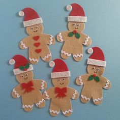 six gingerbread men with hats and bows on their heads are arranged in the shape of santa's helpers