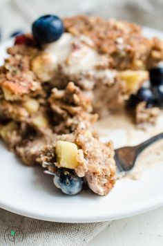 a close up of a plate of food with blueberries and granola on it