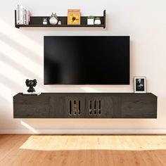 a flat screen tv sitting on top of a wooden entertainment center