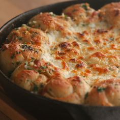 a casserole dish with cheese and herbs in it